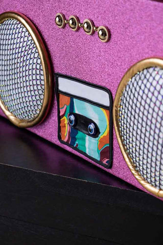 Detail shot of the front of the Handmade Candy Pink Boom Box Decoration.