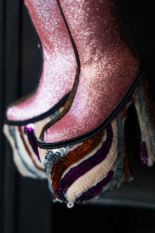 Detailed image of The Handmade Groovy Spiral Platforms Decoration hanging in front of a fireplace.