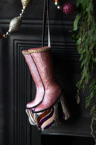 A lifestyle image showing the side of The Handmade Groovy Spiral Platforms Decoration hanging in front of a fireplace.