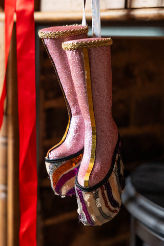 The Handmade Groovy Spiral Platforms Decoration hanging in front of a fireplace.