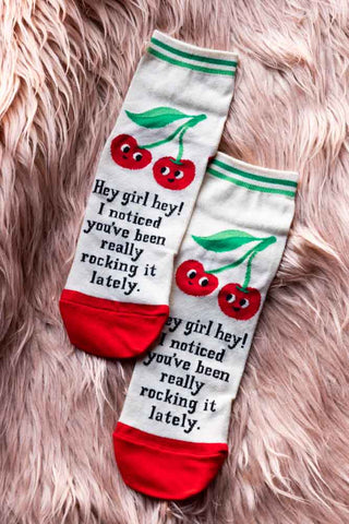 The Hey Girl Women's Ankle Socks on a fluffy pink background.