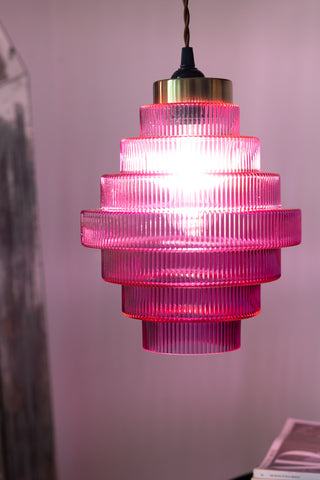 The Hot Pink Tiered Glass Easyfit Ceiling Shade with the light inside switched on.