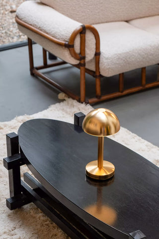 The Humble - Domed Cable-Free Mood Lighting Lighting in Gold displayed on a coffee table.