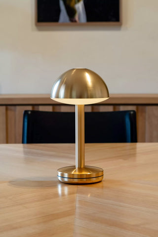 The Humble - Domed Cable-Free Mood Lighting Lighting in Gold displayed on a wooden table.