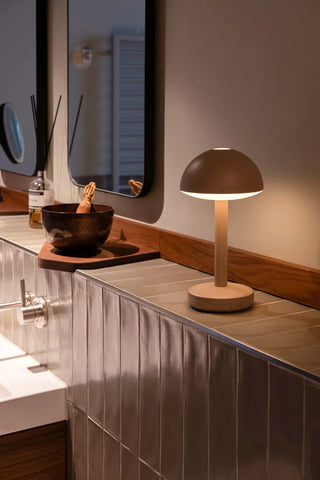 The Humble - Domed Cable-Free Mood Lighting Lighting in Off White displayed on a tiled bathroom shelf.