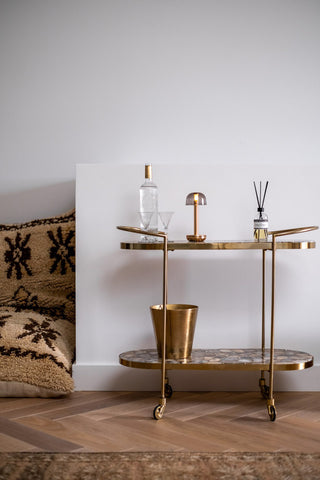 The Humble - Elegant Cable-Free Mood Lighting in Gold & Smoked Glass Shade displayed on a drinks trolley, styled with various home accessories.