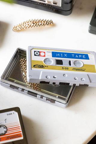 Close-up of the I Made You A Mix Tape Cassette Tape Storage Tin with the lid off and with hairclips inside/around it.