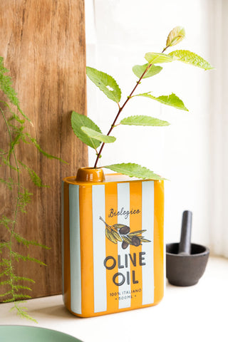 Striped ceramic vase with green stem and olive oil typography and detailing 