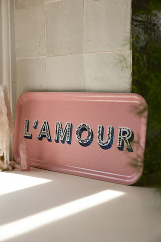 The L'amour Pink Tray leaning against kitchen tiles in the sunshine.