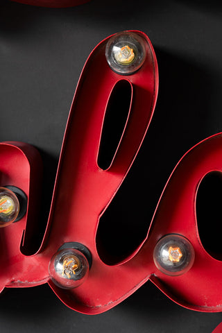 Close-up of the La Dolce Vita Fairground Wall Light on a black wall.