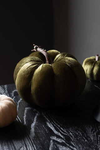 The Large Green Velvet Pumpkin styled with the smaller version in green and cream, on a dark wooden table.