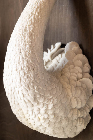 Close-up of the Large White Faux Swan Head Wall Art on a dark wall.