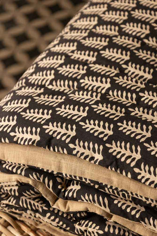 Detail shot of the folded Leaf Print Reversible Quilt in King-Size.