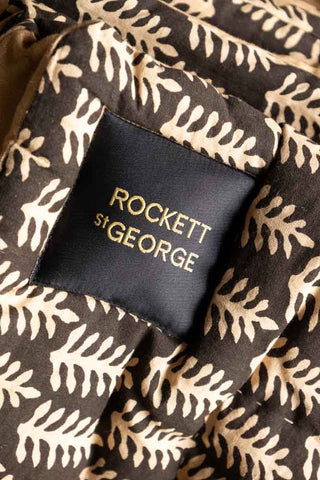 Detail shot of the Rockett St George logo on the Leaf Print Reversible Quilt in King-Size