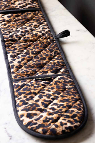 The Luxury Leopard Print Oven Gloves displayed flat on a white marble surface.