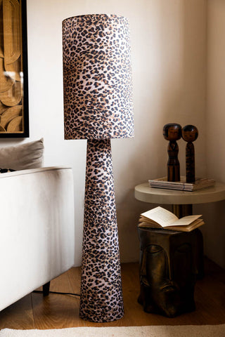 The Leopard Love Print Floor Lamp styled next to a sofa and side table with various home accessories.