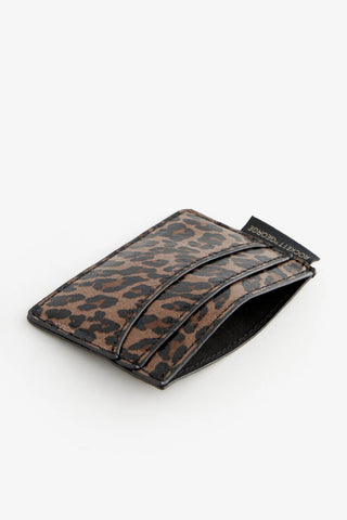 The Leopard Print Card Holder laying down on a white surface.