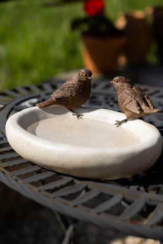 The Love Birds Bowl displayed on a garden table.