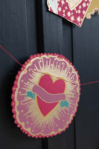 Detail shot of the Love Hearts Paper Garland in front of a black background.