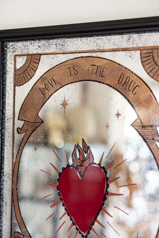 Close-up of the design on the Love Is The Drug Decorative Mirror.