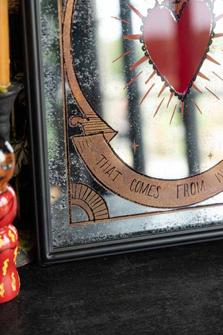 Detail shot of the bottom left-hand corner of the Love Is The Drug Decorative Mirror.