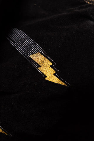 Close-up of the lightning bolt motif on the Reversible Black Lovestruck & Leopard Print Throw.