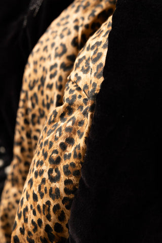 Close-up of the leopard print design on the Reversible Black Lovestruck & Leopard Print Throw.