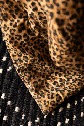 Detail shot of the leopard print on the Reversible Black Lovestruck & Leopard Print Throw.