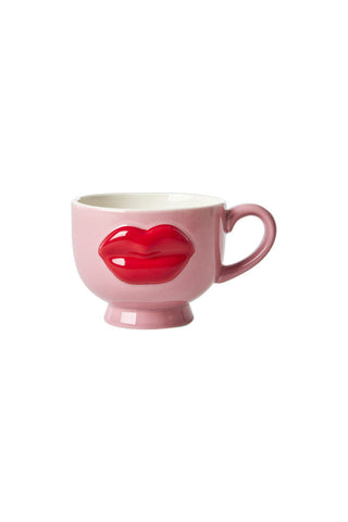 Fun pink coffee mug with a standout red lips decoration in a 3D style on a white background.