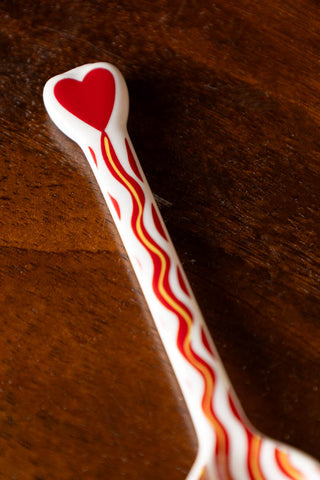 Close-up of the handle of the Made With Love Red Striped Spoon.