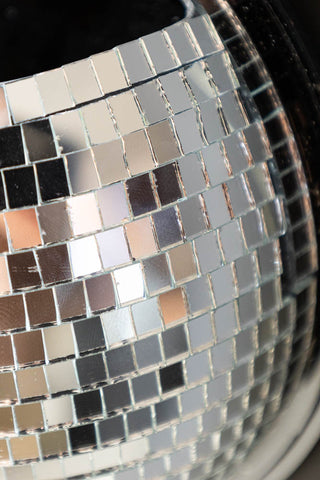 Close-up of silver disco mirror ball holder, showing tiny white tiles 