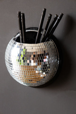 Close up of silver disco ball holder with pens