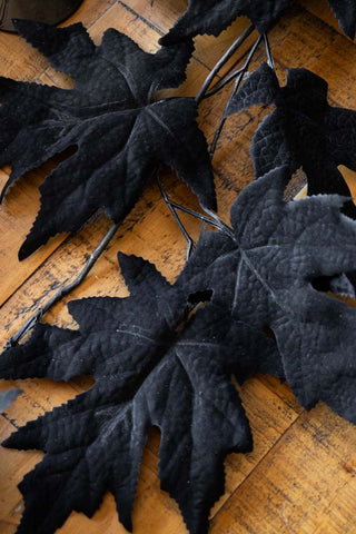 Close-up of the Maple Leaf Garland styled on a wooden surface.