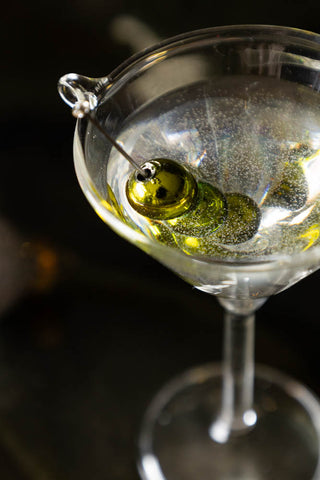 Close-up of the Martini Glass Christmas Tree Decoration seen from above, styled on a dark surface.