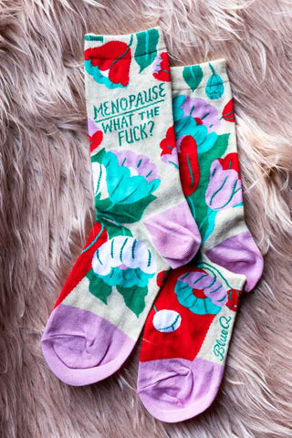 The Menopause Crew Socks displayed on a fluffy pink background.