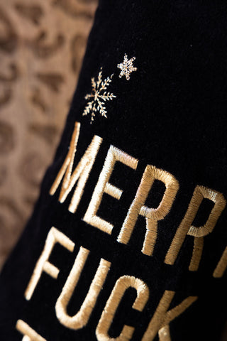 Detail shot of the text and snowflake motifs on the Merry Fuck This Black Christmas Stocking.