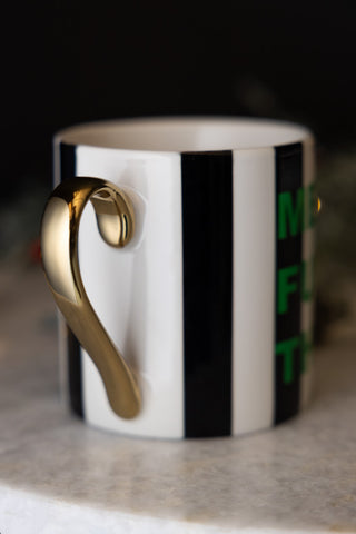 Close-up of the handle on the Merry Fuck This Stripe Mug.