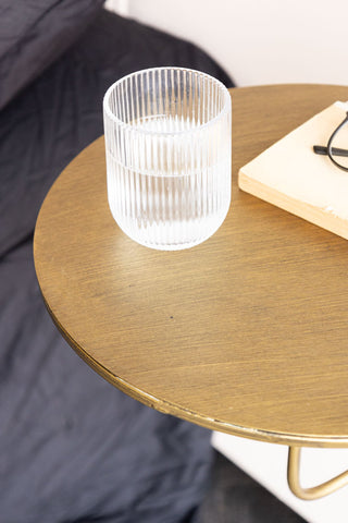 The Metal Table & Wall Shelf styled with a glass of water, book and pair of glasses on, next to a bed.