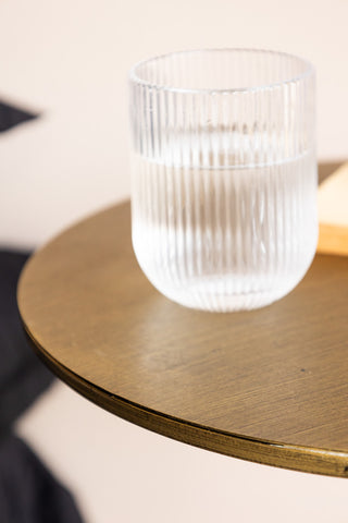 Detail shot of the edge of the Metal Table & Wall Shelf with a glass of water on top.