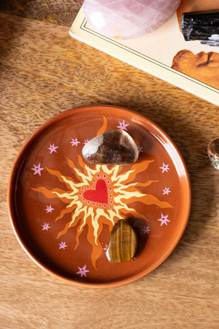 The Milagro Heart On Fire Small Side Plate styled as a decorative plate with small accesories.