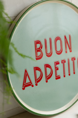 Close-up of the Mint Green Buon Apetito Plate styled leaning against the wall.