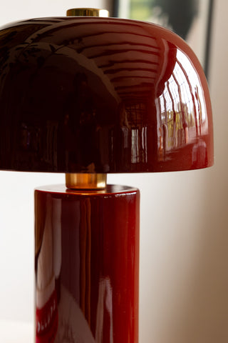 Extreme close-up of glossy burgundy table lamp