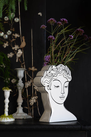 The Peaceful Monochrome Lady Vase seen from a side angle, styled with flowers inside.