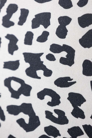 Close-up of the print on the Monochrome Leopard Sit The Fuck Down Cushion.