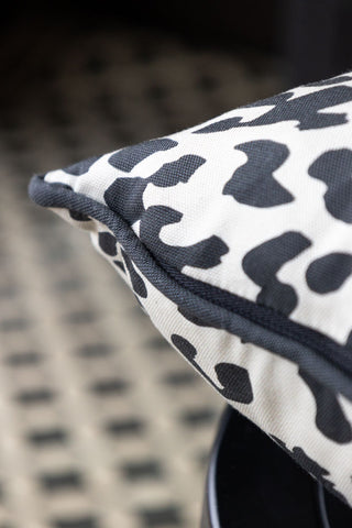 Close-up of the piping on the Monochrome Leopard Sit The Fuck Down Cushion.