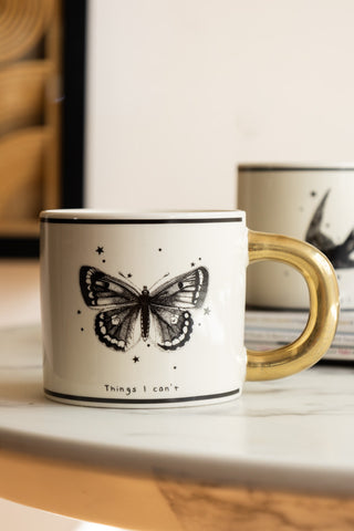 Monochrome Set of 2 Tattoo Mugs against light background close up