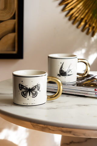 Monochrome Set of 2 Tattoo Mugs against light background with gold accents