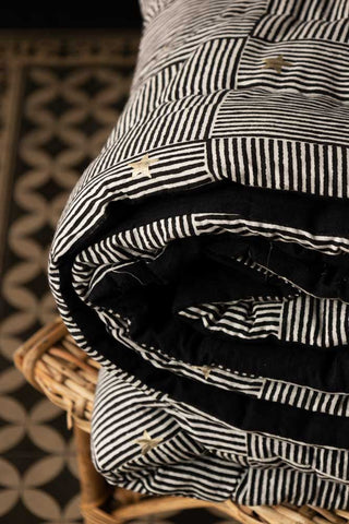 Close-up of the folded Monochrome & Gold Star Detail Print Quilt in King-Size.