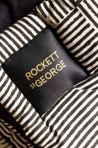 Close-up of the label with the Rockett St George logo on the Monochrome & Gold Star Detail Print Quilt in King-Size.