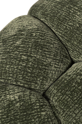 A stunning green armchair, showing the texture of the chair.